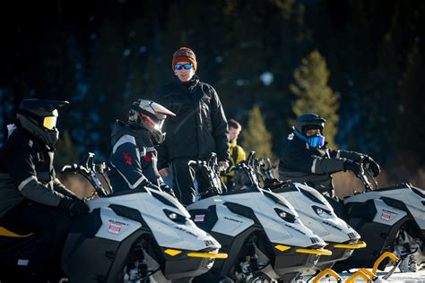 Rider riding up a snowy mountain on the 2027 Ski-Doo Summit