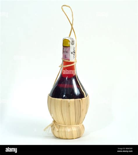 a classic italian chianti red wine bottle on a white cut out background ...