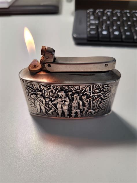 My grandma was cleaning and found this old silver table lighter. She was gonna throw it out, but ...