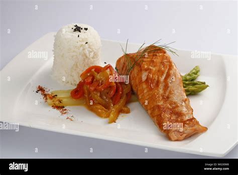 Close-up on salmon fillet with fruit salsa, over rice.