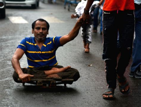 Specially-abled person being assisted by a family member