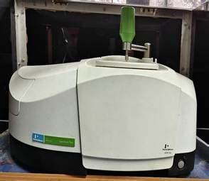 A white machine with a green handleAI-generated content may be incorrect.