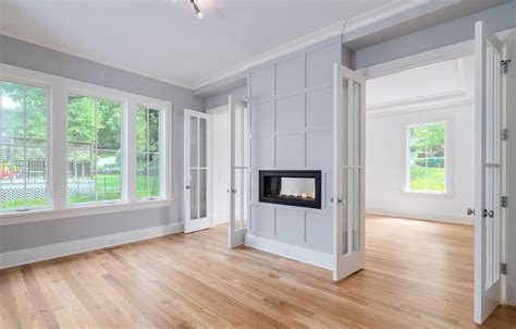 modern farmhouse interior design. wood floors. fireplace. light grey ...