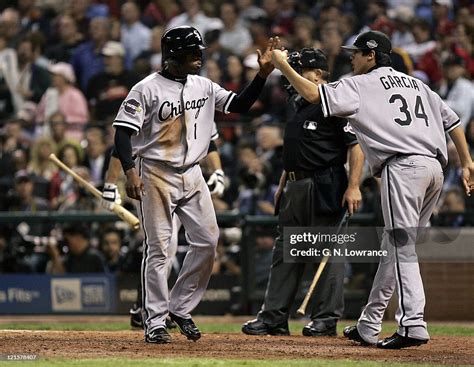 Willie Harris of the Chicago White Sox is congratulated after scoring ...