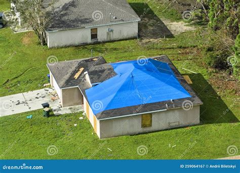 Top View of Leaking House Roof Covered with Protective Tarp Sheets Against Rain Water Leaks ...