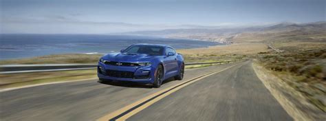 https://di-uploads-pod2.dealerinspire.com/carlblackchevynashville/uploads/2019/05/blue-2020-Chevy-Camaro-driving-on-coastal-highway_o.jpg