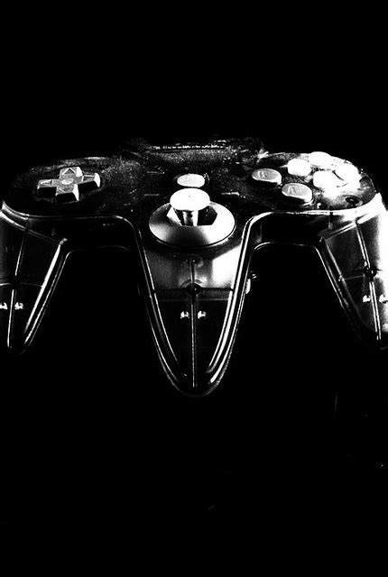a black and white photo of two video game controllers with buttons on ...