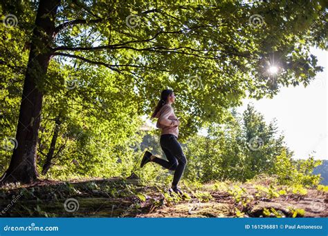 Young Girl Jogging in the Woods on a Sunny Morning. Stock Image - Image ...
