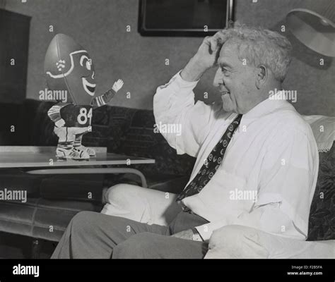 Amos Alonzo Stagg smiling at football creature. On his 84th birthday ...