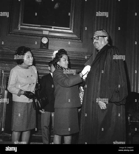 New Supreme Court Justice Thurgood Marshall has his robe buttoned by ...