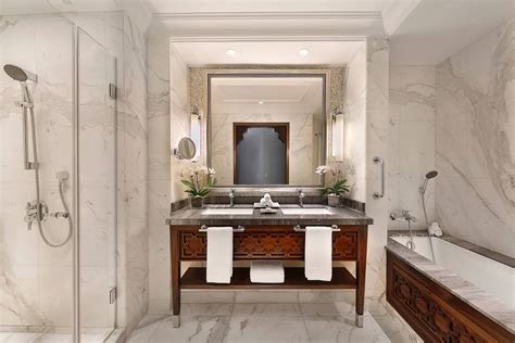 The Ritz-Carlton bath mat hung over standing bathtub