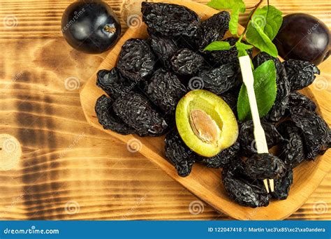 Prune, Dried Plums Fruits on Rustic Wooden Background. Dry Plums in a ...