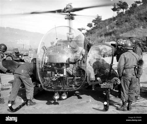 KOREAN WAR: HELICOPTER. /nU.S. soldiers load two stretcher cases onto a ...