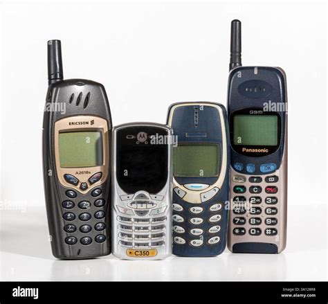 Four retro cellular phones of famous brands standing upright against a ...