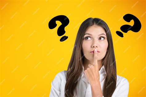 Premium Photo | Young woman posing with question marks