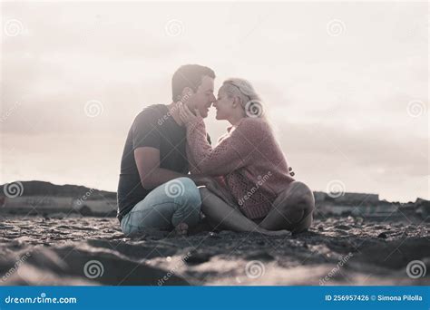 Romantic Evening with Girl and Boy Together Sitting at the Beach on the ...