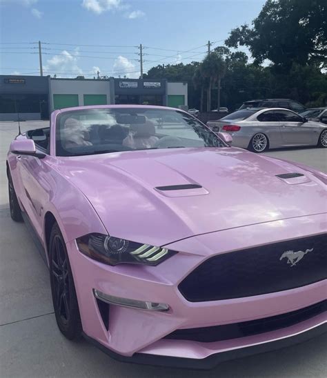 Pink Mustang parked in a lot