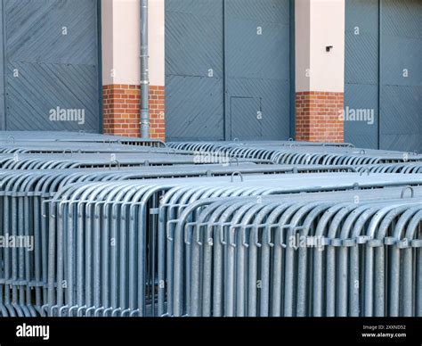 Stored police crowd control barriers made of steel stacked in front of ...