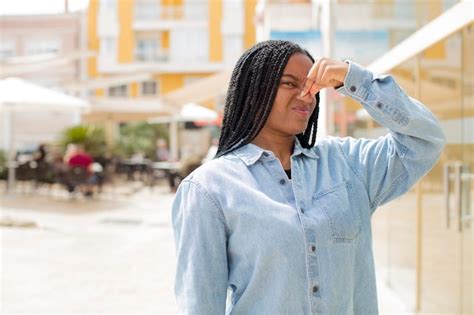 Premium Photo | Feeling disgusted holding nose to avoid smelling a foul ...