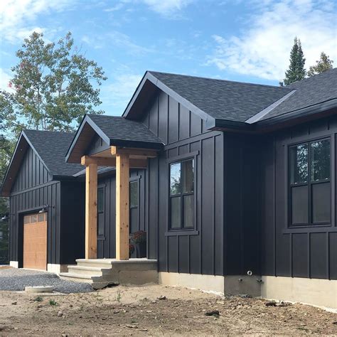 Modern Farmhouse Exterior with Black Siding and Wood Trim