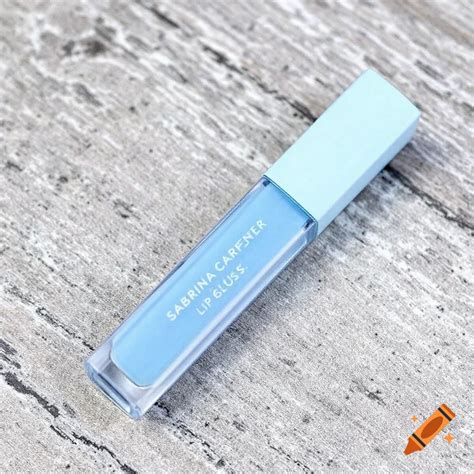 Sabrina Carpenter light blue lip gloss with kiss charms on Craiyon