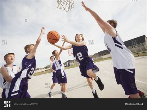 Group of children playing basketball stock photo - OFFSET