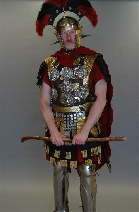 This living historian dresses as a Centurion. Centurions wore greaves, mail, or scale body armor ...