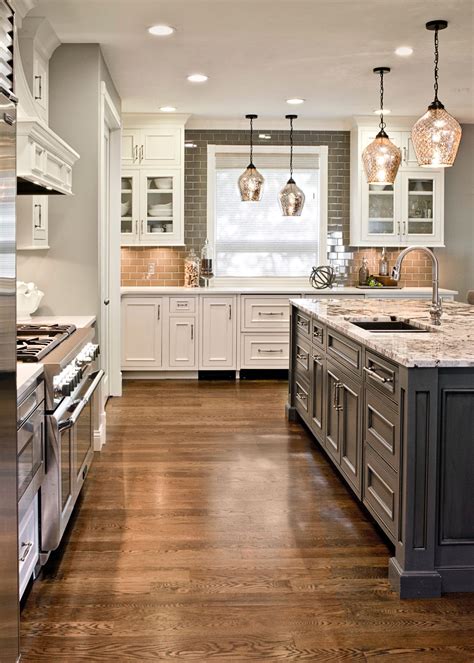 Gray Island with White Cabinets and Granite Top in a Modern Kitchen
