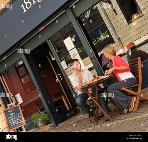 Couple eating out at lunchtime in Bangor High Street, Gwynedd Stock ...