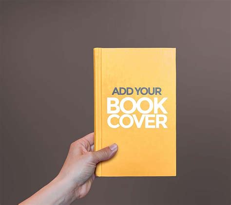 Free Hardcover Book In Hand Mockup (PSD)