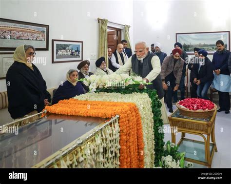 New Delhi, India. 27th Dec, 2024. Indian Prime Minister Narendra Modi, center, visits the home ...