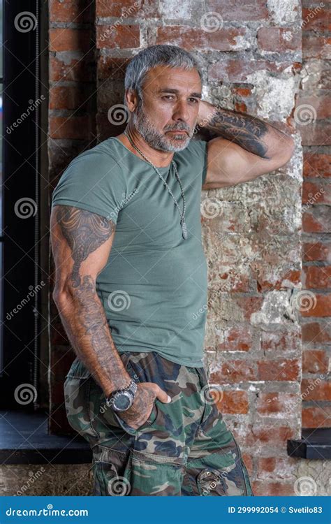 A Soldier in Camouflage, a Soldier Stands Against the Wall.a Mature ...