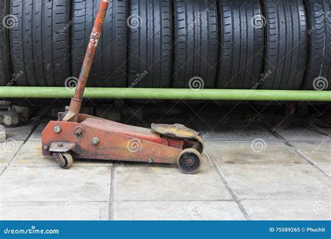 The Old Floor Jack with the Car Used Tire Stack Stock Image - Image of ...