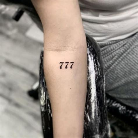 777 spine tattoo,This design symbolizes luck and fortune