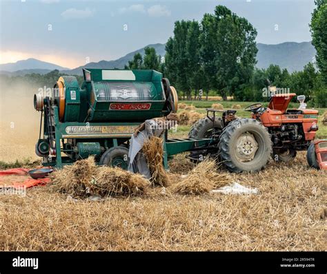 Tractor with thresher machine operating in the agriculture field in swat valley of Pakistan ...