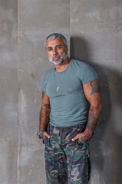 A Soldier in Camouflage, a Soldier Stands Against the Wall.a Mature ...