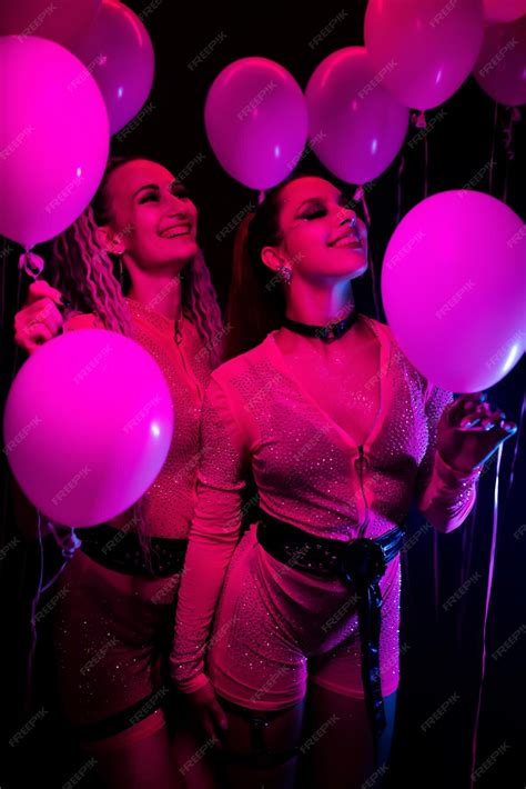 Premium Photo | Portrait of two beautiful gogo dancers posing with ...