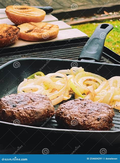Cooking Minced Beef Burger on Cast Iron Grill Skillet Outdoors, Red ...