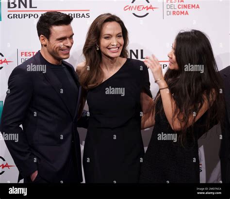From left, Richard Madden, Angelina Jolie, and director Chloé Zhao pose ...