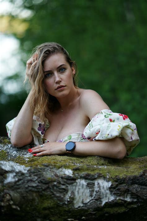 Sexy Woman in Dress Posing near Tree Trunk in Nature · Free Stock Photo
