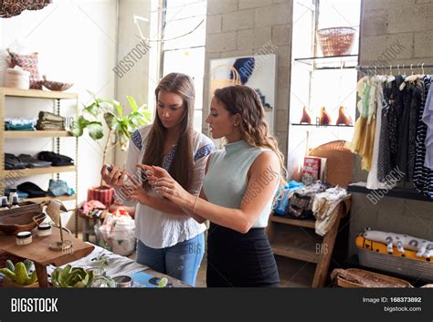 Premium Photo | Female shop assistant talking to customer
