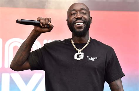 Download Freddie Gibbs Performingon Stage Wallpaper | Wallpapers.com