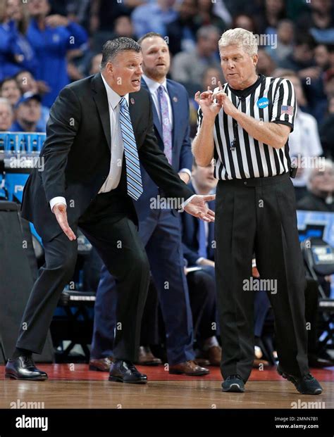 Creighton coach Greg McDermott, left, argues a call during the first ...