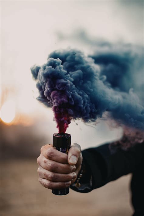 Download wallpaper 3648x5472 smoke bomb, hand, smoke, cloud hd background