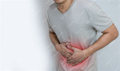 Man suffering from stomach ache with both palm around waistline to show pain and injury on belly ...