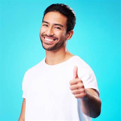 Smile thumbs up and portrait of a man in a studio with a satisfaction ...