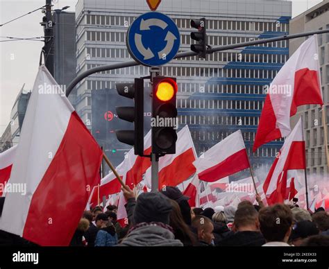Polish flags carried by marchers in the Independence Day parade ...