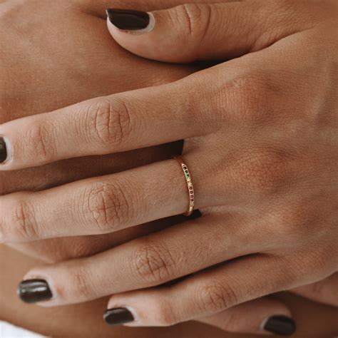 Indigenous woman wearing engagement ring on cliffside during golden hour