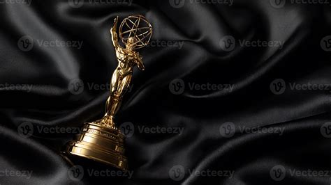 Golden Emmy Award trophy statuette resting on a luxurious, draped black ...
