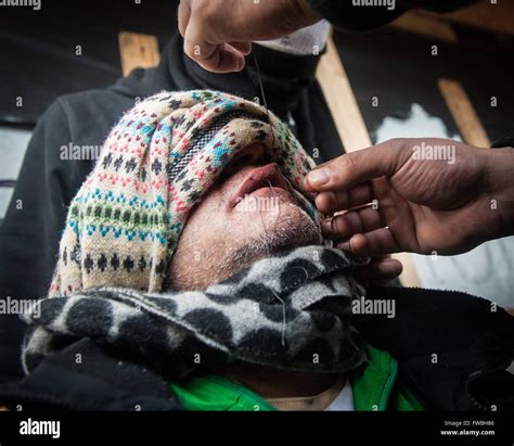 A desperate Iranian refugee has his mouth sown shut in order to signify ...